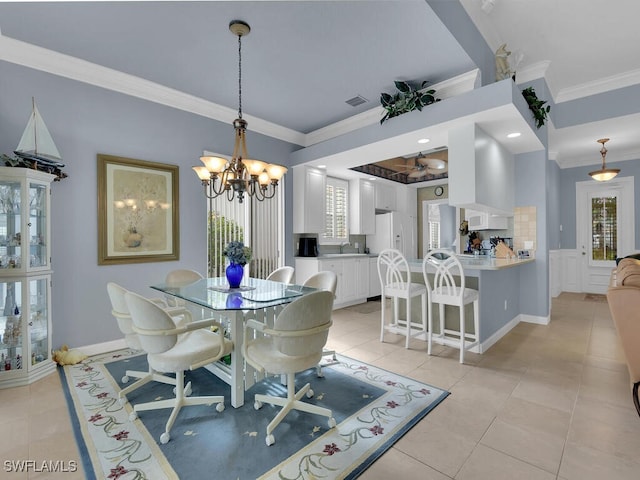 tiled dining space with a chandelier, ornamental molding, and sink