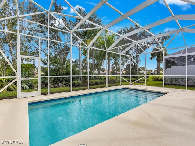 view of swimming pool featuring a lanai and a patio