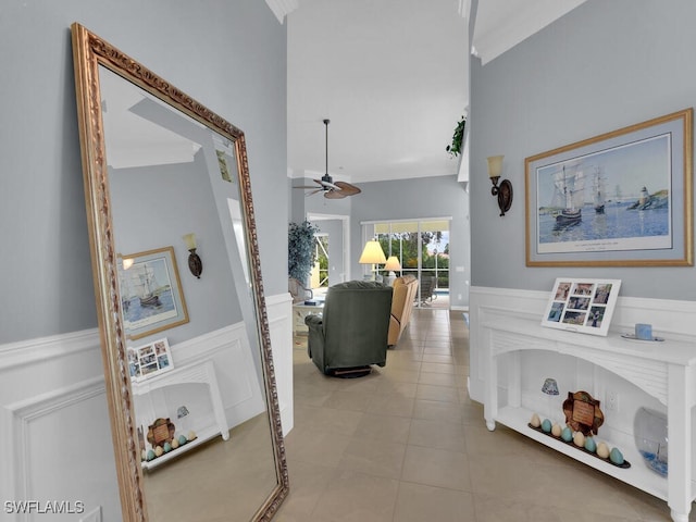 hall with light tile patterned flooring and ornamental molding