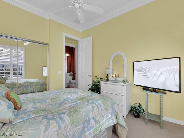 carpeted bedroom with a closet, ceiling fan, and ornamental molding