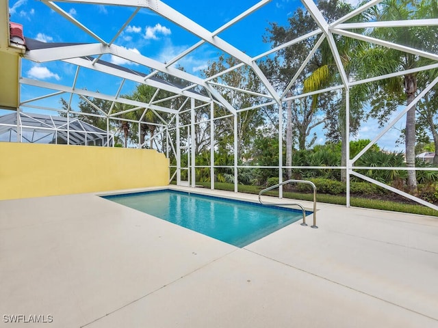 view of swimming pool featuring a lanai and a patio