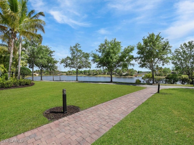 surrounding community featuring a water view and a yard