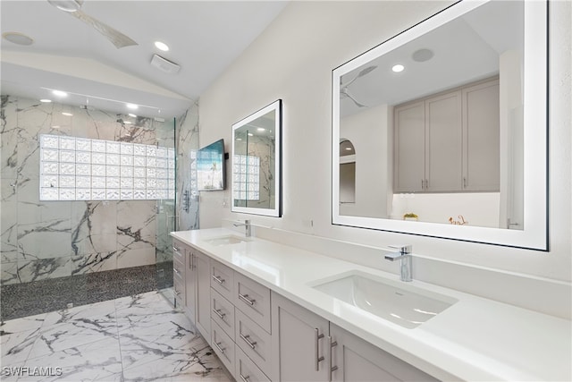 bathroom featuring vanity, vaulted ceiling, and tiled shower