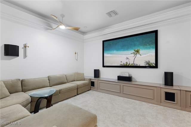 cinema with ceiling fan, light colored carpet, and ornamental molding