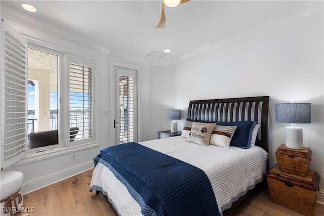 bedroom featuring ceiling fan, wood-type flooring, and crown molding