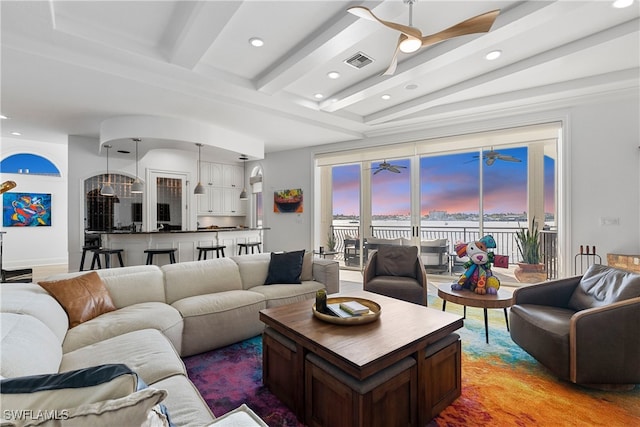 living room featuring beamed ceiling