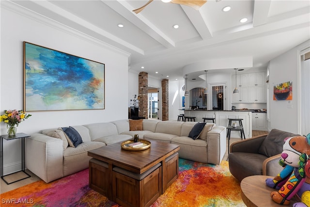 living room with beam ceiling and ceiling fan