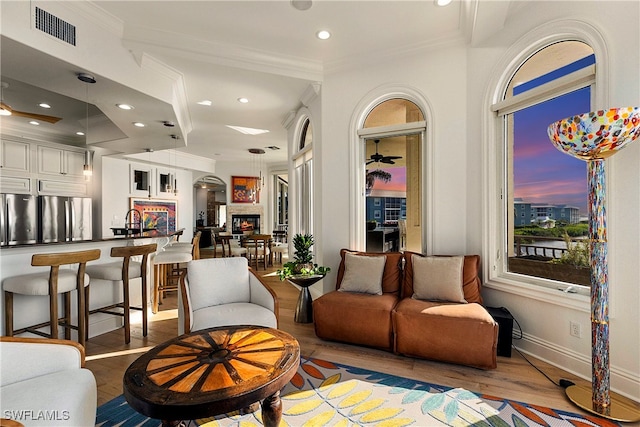 interior space with light hardwood / wood-style floors and ornamental molding