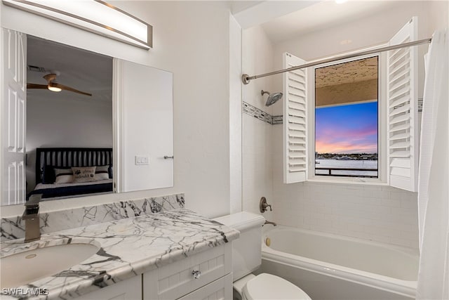 full bathroom featuring ceiling fan, vanity, shower / bath combo, and toilet