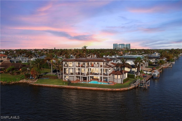 aerial view at dusk with a water view