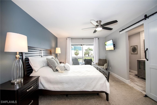 carpeted bedroom with access to exterior, a barn door, and ceiling fan