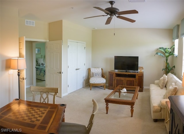 living room with ceiling fan and light colored carpet