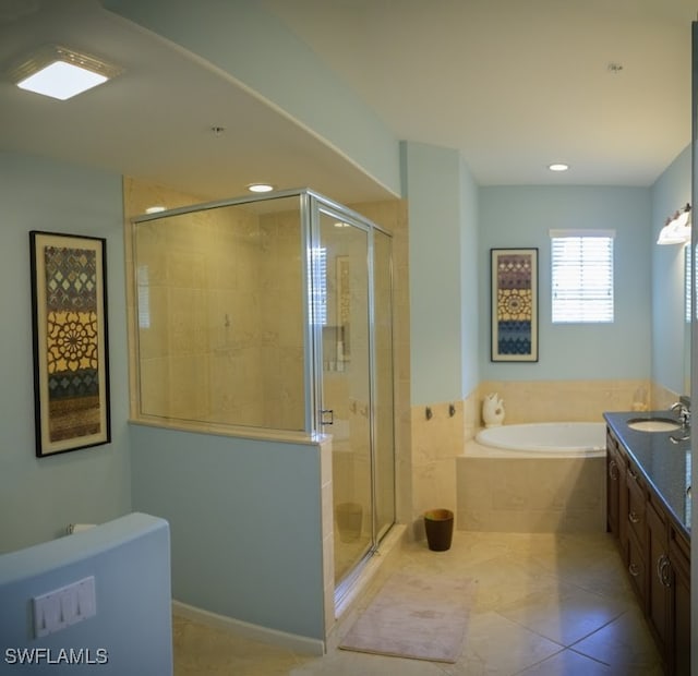 bathroom with tile patterned floors, vanity, and separate shower and tub