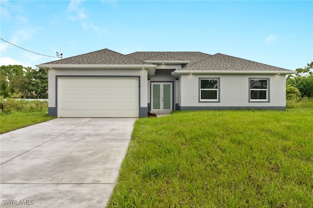 view of front facade featuring french doors, a front yard, and a garage