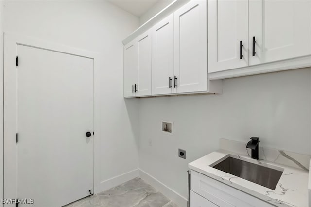 clothes washing area with cabinets, washer hookup, electric dryer hookup, and sink