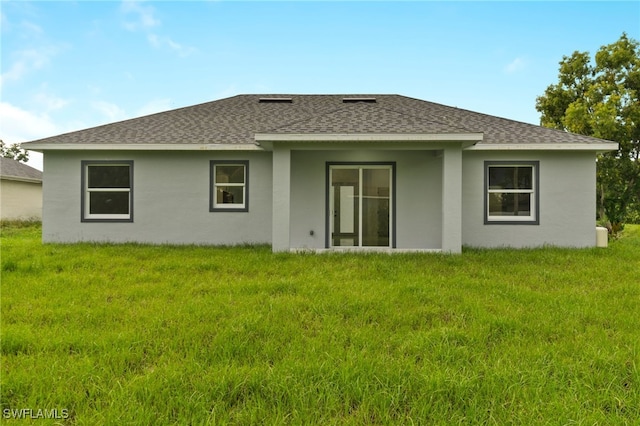 rear view of house with a yard