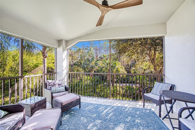 sunroom / solarium with ceiling fan and vaulted ceiling