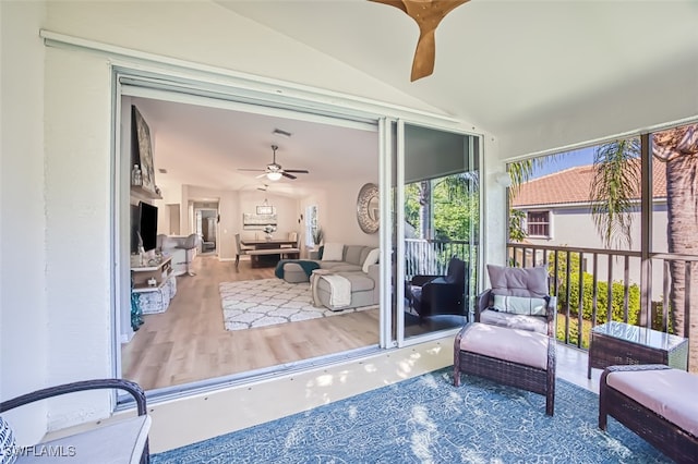 sunroom with ceiling fan and lofted ceiling