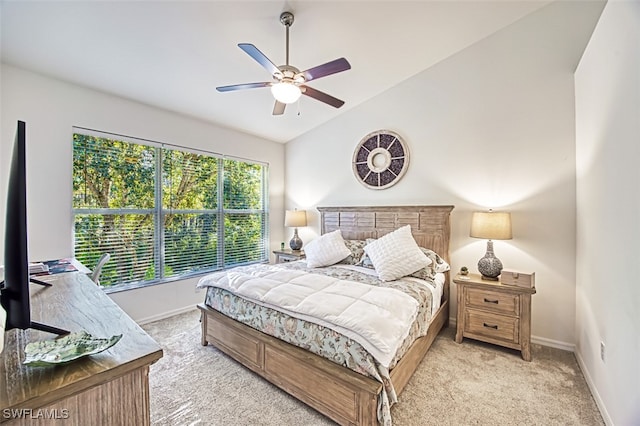 bedroom featuring ceiling fan, light colored carpet, and lofted ceiling