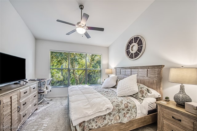 carpeted bedroom with ceiling fan and lofted ceiling