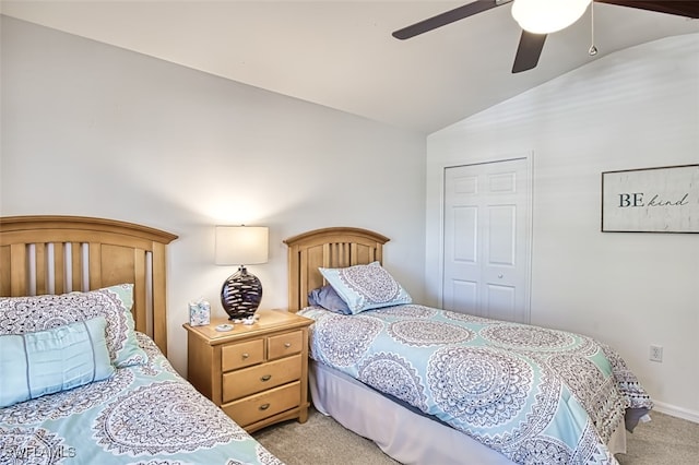 carpeted bedroom with ceiling fan, a closet, and lofted ceiling