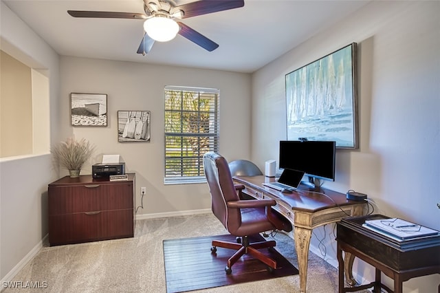 carpeted office space with ceiling fan