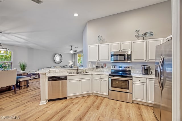 kitchen featuring white cabinetry, stainless steel appliances, and a wealth of natural light