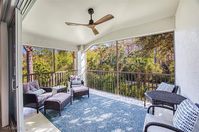 sunroom / solarium with ceiling fan and lofted ceiling