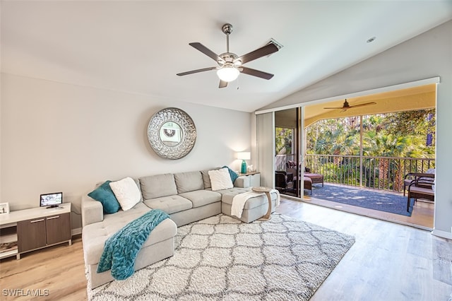 living room with light wood-type flooring, vaulted ceiling, and ceiling fan