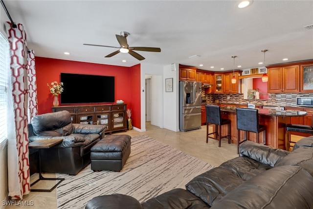 tiled living room featuring ceiling fan