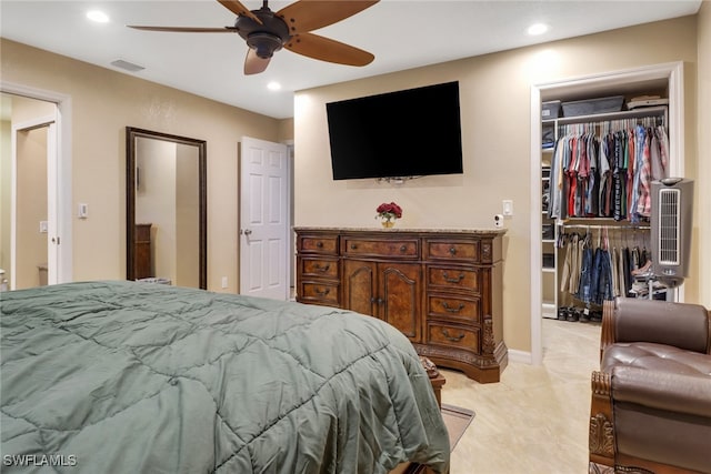 carpeted bedroom featuring ceiling fan and a closet