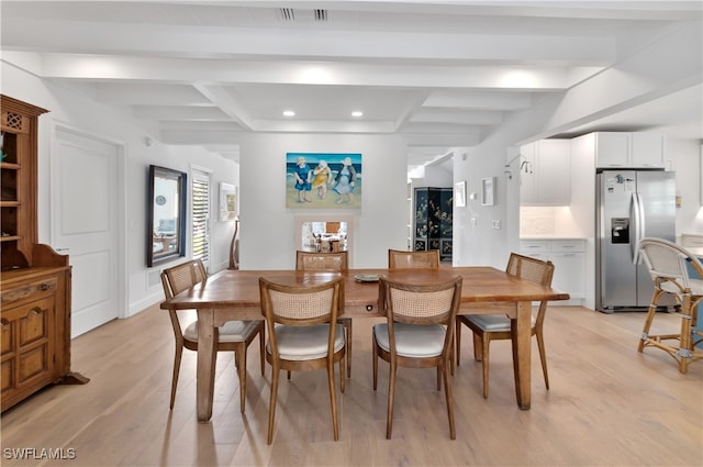 dining area with beam ceiling and light wood-type flooring