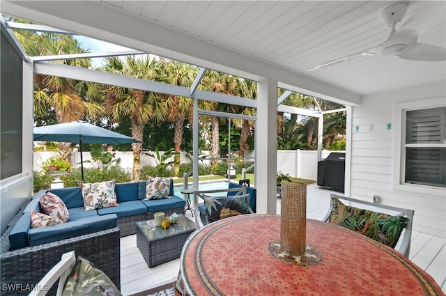 sunroom featuring ceiling fan, a healthy amount of sunlight, and wood ceiling