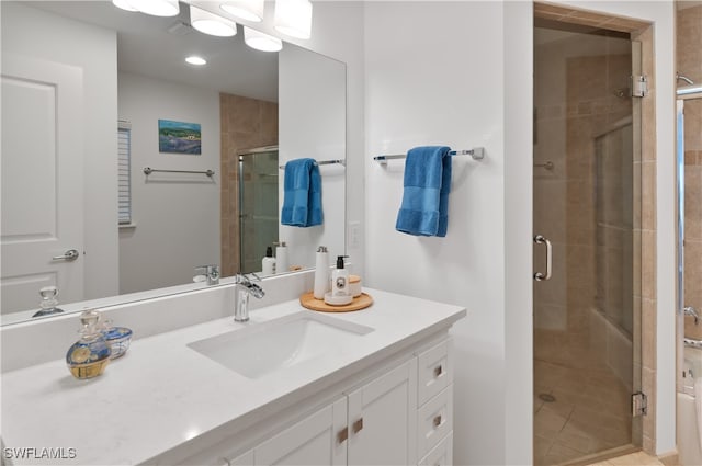 bathroom with tile patterned floors, vanity, and walk in shower