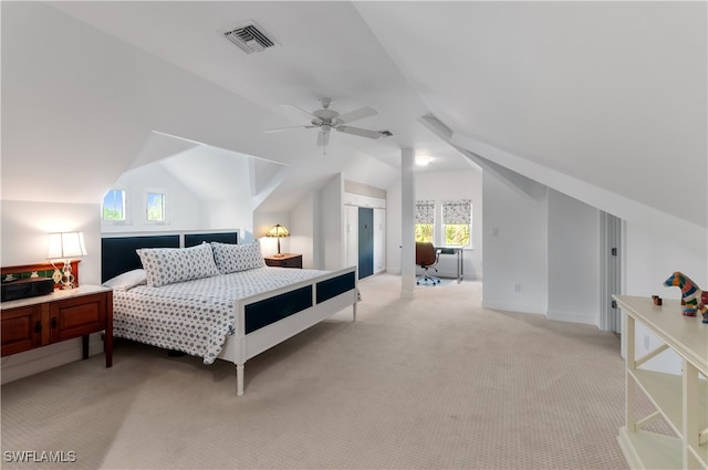 bedroom with ceiling fan, light colored carpet, and lofted ceiling