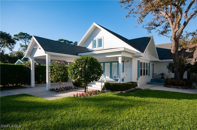 rear view of house featuring a lawn