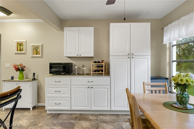 kitchen featuring white cabinetry and ceiling fan