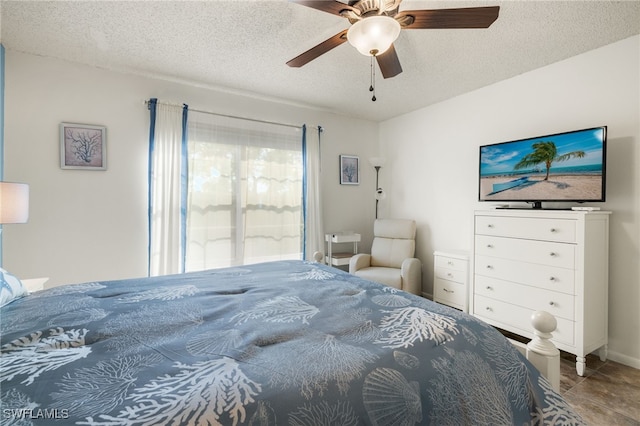 bedroom featuring ceiling fan and a textured ceiling