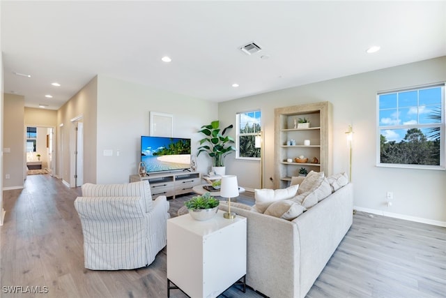 living room featuring plenty of natural light and light wood-type flooring