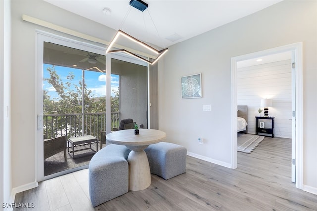 living area featuring light hardwood / wood-style flooring and ceiling fan