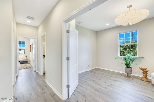 hall with light hardwood / wood-style floors