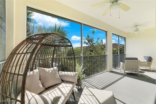 sunroom / solarium featuring ceiling fan