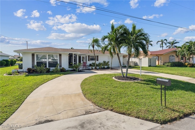 ranch-style home with a garage and a front lawn