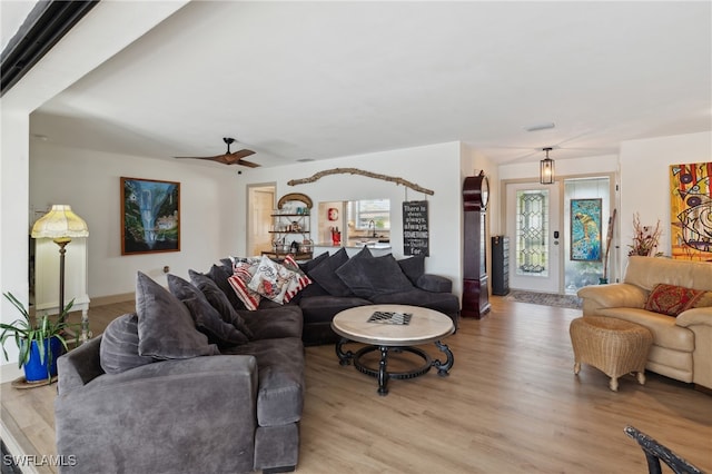 living room featuring ceiling fan and light hardwood / wood-style flooring