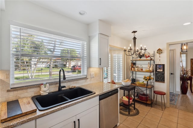 kitchen with dishwasher, white cabinets, a wealth of natural light, and sink