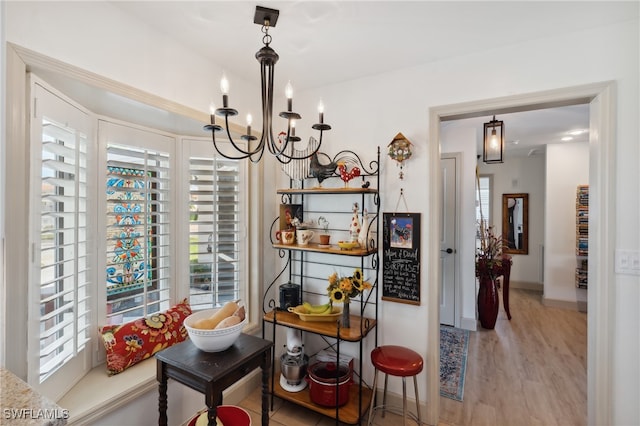 dining room featuring plenty of natural light, light hardwood / wood-style floors, and a chandelier