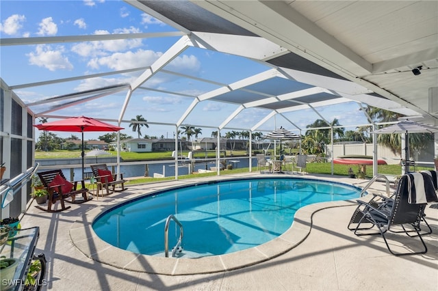 view of swimming pool featuring glass enclosure, a water view, and a patio