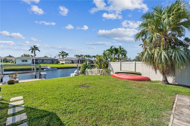 view of yard featuring a water view and a dock