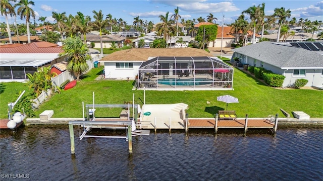 view of dock with glass enclosure, a water view, and a yard