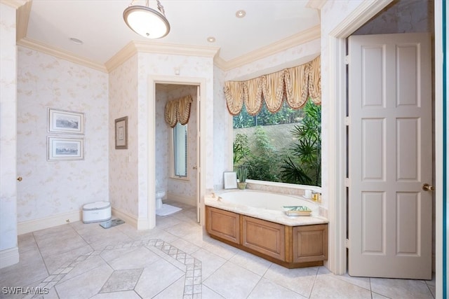 bathroom featuring tile patterned flooring, toilet, crown molding, and a tub